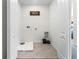 Clean and well-lit laundry room with tile flooring, washer/dryer hookups and storage options at 6006 Galloping Dr, Apopka, FL 32712