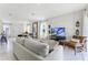 Bright living room featuring modern decor, large windows and stylish furnishings at 6006 Galloping Dr, Apopka, FL 32712