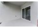 This covered patio features a neutral stucco wall with a glass sliding door leading inside at 6006 Galloping Dr, Apopka, FL 32712