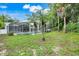 Expansive backyard with screened pool and lush greenery, offering a private outdoor oasis at 6609 Crenshaw Drive, Orlando, FL 32835