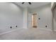 This bedroom has neutral walls, carpet, and access to an ensuite bathroom at 6609 Crenshaw Drive, Orlando, FL 32835