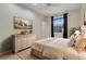 Bright bedroom featuring neutral walls, a plush bed with floral pillows, and a decorative painting at 6609 Crenshaw Drive, Orlando, FL 32835
