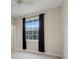 Bright bedroom featuring neutral walls, black curtains, and a window offering pleasant outdoor views at 6609 Crenshaw Drive, Orlando, FL 32835