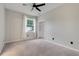 Neutral bedroom with a carpeted floor, window with backyard view, and a closet at 6609 Crenshaw Drive, Orlando, FL 32835