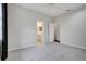 This bedroom has neutral walls, carpet, a ceiling fan, and access to an ensuite bathroom at 6609 Crenshaw Drive, Orlando, FL 32835