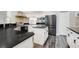 Modern kitchen with stainless steel appliances, center island, and sleek black countertops at 6609 Crenshaw Drive, Orlando, FL 32835