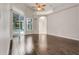 Bright living room with wood-look tile floors, high ceilings and sliding glass doors to a screened pool area at 6609 Crenshaw Drive, Orlando, FL 32835