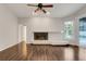 Living room featuring a corner fireplace, hardwood floors, and views of the backyard pool at 6609 Crenshaw Drive, Orlando, FL 32835