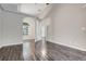 Open-plan living room featuring tile floors, neutral walls, and an arched doorway leading to another room at 6609 Crenshaw Drive, Orlando, FL 32835