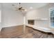 Spacious living room with fireplace, hardwood floors, and large window offering pool views at 6609 Crenshaw Drive, Orlando, FL 32835