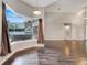 Bright living room with hardwood floors, large window with views of screened in pool and spa at 6609 Crenshaw Drive, Orlando, FL 32835