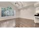 Bright and airy living room featuring wood-look tile flooring and a large arched window at 6609 Crenshaw Drive, Orlando, FL 32835