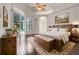 Cozy main bedroom featuring a wood bed frame, floral rug, and sliding doors to a private pool area at 6609 Crenshaw Drive, Orlando, FL 32835