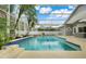 Resort-style screened pool with lush landscaping, ideal for relaxation and outdoor gatherings at 6609 Crenshaw Drive, Orlando, FL 32835