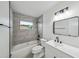 Modern bathroom features a sleek vanity, updated lighting, and a shower-tub combo for relaxation at 772 Whippoorwill Dr, Orlando, FL 32825