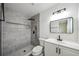 Modern bathroom features a stylish vanity, updated lighting, and a frameless walk-in shower with tile at 772 Whippoorwill Dr, Orlando, FL 32825