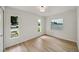 Bright bedroom features wood floors, multiple windows, and neutral walls, ready for personalization at 772 Whippoorwill Dr, Orlando, FL 32825