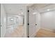 The hallway features wood floors, a sliding door with natural light, and a door to the laundry room at 772 Whippoorwill Dr, Orlando, FL 32825