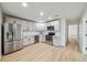 Modern kitchen features stainless appliances, stylish cabinets, and ample counter space for meal preparation at 772 Whippoorwill Dr, Orlando, FL 32825