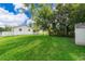 Lush backyard with green grass and a shed, offering a private and serene outdoor space at 824 Timor Ave, Orlando, FL 32804