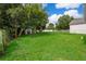 Spacious backyard with green grass and utility shed, perfect for outdoor activities and storage at 824 Timor Ave, Orlando, FL 32804