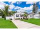 Charming home with a well-manicured lawn, welcoming front porch, and a driveway, exuding curb appeal at 824 Timor Ave, Orlando, FL 32804