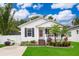 Charming single-story home with a well-manicured lawn, complemented by a small front porch and landscaped garden beds at 824 Timor Ave, Orlando, FL 32804