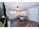 Inviting living room with a ceiling fan, gray walls, wood-look floors, and abundant natural light from multiple windows at 824 Timor Ave, Orlando, FL 32804