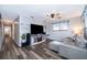 Open-concept living room featuring gray walls, sleek flooring, a ceiling fan, and a comfortable seating area at 824 Timor Ave, Orlando, FL 32804