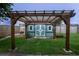 Charming backyard shed with a wooden pergola, set in a well-maintained yard at 8718 Fort Shea Ave, Orlando, FL 32822