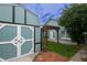 Charming backyard shed and wooden pergola, surrounded by green grass and mulch at 8718 Fort Shea Ave, Orlando, FL 32822