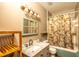 Stylish bathroom featuring a marble vanity, and a tub with a decorative shower curtain at 8718 Fort Shea Ave, Orlando, FL 32822