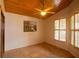 Well-lit bedroom with tile floors and wood ceiling, complemented by a serene landscape painting at 8718 Fort Shea Ave, Orlando, FL 32822
