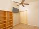 Spacious bedroom featuring tile floors, a ceiling fan, and built-in shelving at 8718 Fort Shea Ave, Orlando, FL 32822