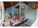 Inviting front porch featuring a swing, rocking chairs, and wood ceiling at 8718 Fort Shea Ave, Orlando, FL 32822