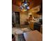 Kitchen boasts wood cabinets, a brick accent wall, unique hanging pot rack, and stone tile flooring at 8718 Fort Shea Ave, Orlando, FL 32822