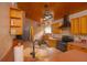 Rustic kitchen featuring wood cabinets, brick wall accents, and unique light fixtures at 8718 Fort Shea Ave, Orlando, FL 32822