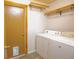 Functional laundry room featuring a washer, dryer, and ample storage space at 8718 Fort Shea Ave, Orlando, FL 32822