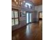 Open-concept living room with hardwood flooring, plantation shutters, and high vaulted ceilings at 8718 Fort Shea Ave, Orlando, FL 32822