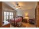 Comfortable bedroom featuring window with plantation shutters and ceiling fan at 8718 Fort Shea Ave, Orlando, FL 32822