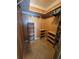This walk-in closet is complete with wood paneling, shelving, and tile flooring at 8718 Fort Shea Ave, Orlando, FL 32822