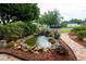 Beautiful water feature with pond, plants, and decorative rocks in the front yard at 8718 Fort Shea Ave, Orlando, FL 32822