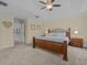 Comfortable bedroom with beige colored walls, a decorative rug, and a queen sized bed at 9034 Paolos Place Paolos Place, Kissimmee, FL 34747