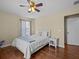 Cozy bedroom with wood floors, a nice window, and a comfortable bed with a throw blanket at 9034 Paolos Place Paolos Place, Kissimmee, FL 34747