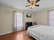A neutral bedroom with a flat screen TV and a nice patterned throw blanket across the bed at 9034 Paolos Place Paolos Place, Kissimmee, FL 34747
