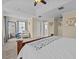 This is a bright bedroom with a comfy chair, a bed, and large windows for natural light at 9034 Paolos Place Paolos Place, Kissimmee, FL 34747