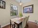 Cozy dining area featuring a wooden table set, with natural light from the window at 9034 Paolos Place Paolos Place, Kissimmee, FL 34747