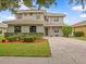 Two-story home with a well-maintained lawn and manicured landscaping at 9034 Paolos Place Paolos Place, Kissimmee, FL 34747