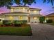 Charming two-story home with a well-manicured lawn and a paved driveway at 9034 Paolos Place Paolos Place, Kissimmee, FL 34747