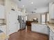 Open kitchen with granite countertops, stainless steel appliances, and views into the living room at 9034 Paolos Place Paolos Place, Kissimmee, FL 34747